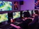 Engaged gamers in a competitive FAFA828 online gaming session showcasing advanced gear and vibrant atmosphere.